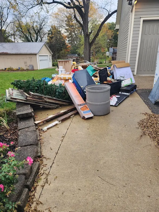 Dumpster being loaded with debris for Estate Cleanout Dumpster Rental in West Caln